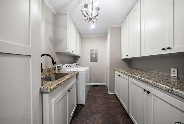 laundry room featuring cabinets, sink, a chandelier, washer and clothes dryer, and crown molding