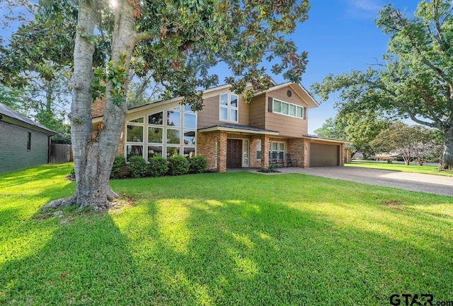 view of front of home with a front lawn and a garage