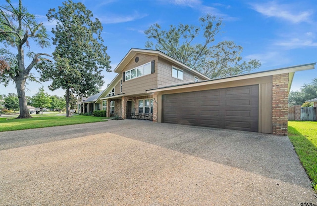 view of front of home with a garage and a front yard