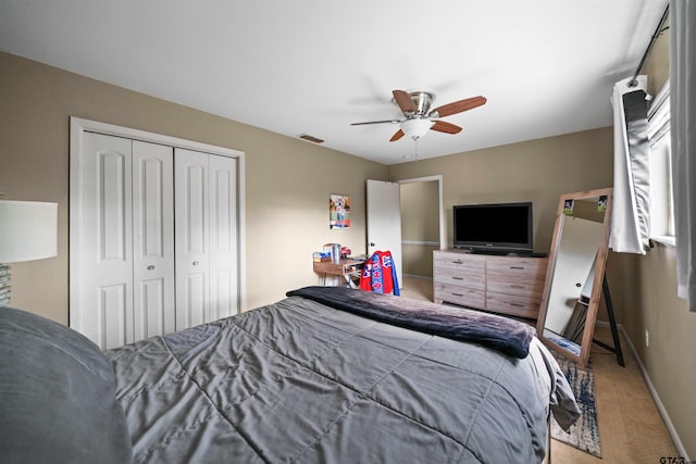 carpeted bedroom with a closet and ceiling fan