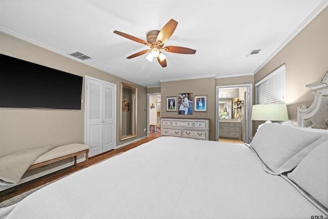 bedroom featuring hardwood / wood-style flooring, connected bathroom, ceiling fan, crown molding, and a closet