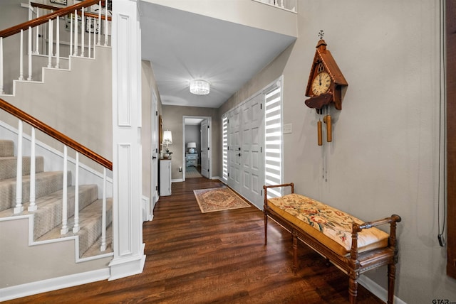 entryway with dark hardwood / wood-style flooring