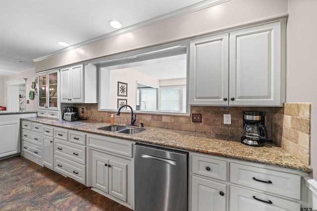 kitchen featuring white cabinetry, sink, tasteful backsplash, light stone countertops, and dishwasher