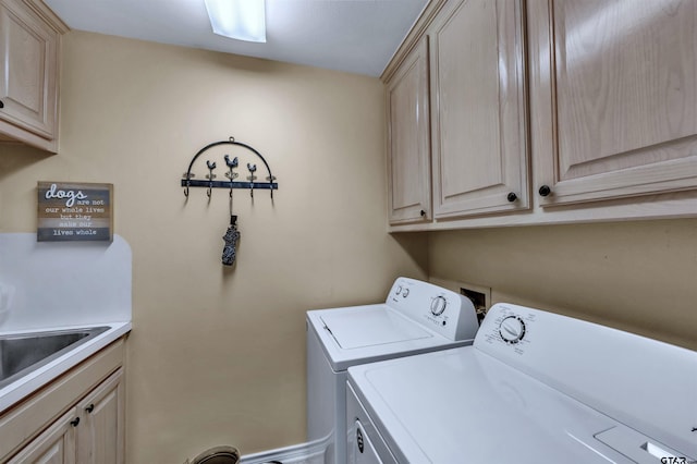 clothes washing area featuring cabinets, separate washer and dryer, and sink