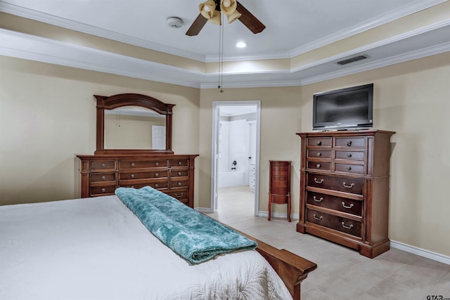 bedroom with ceiling fan, a raised ceiling, crown molding, and ensuite bath