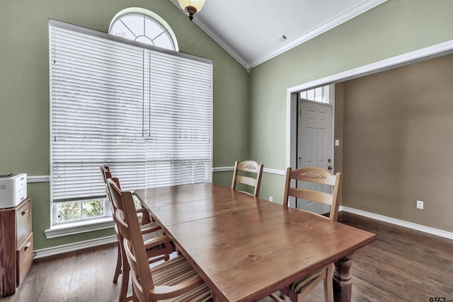 dining area with a wealth of natural light, crown molding, dark hardwood / wood-style floors, and vaulted ceiling