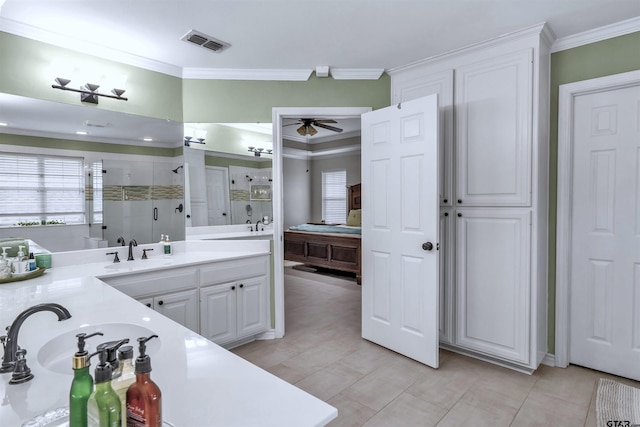 bathroom featuring walk in shower, crown molding, vanity, and ceiling fan