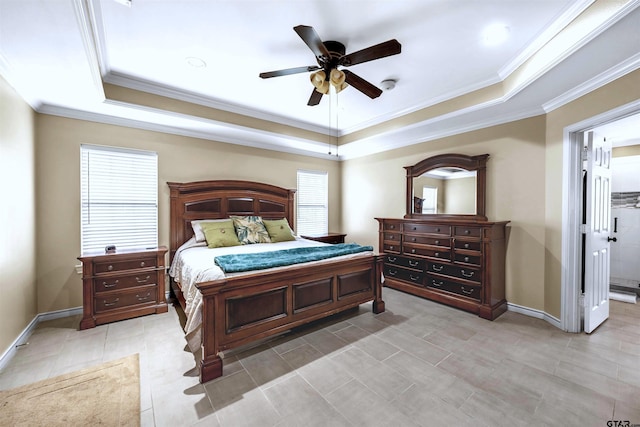 bedroom featuring ceiling fan, multiple windows, and a tray ceiling