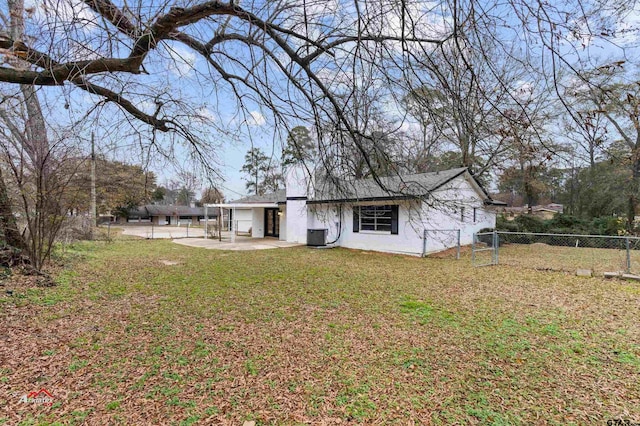 back of house with a yard and a patio area