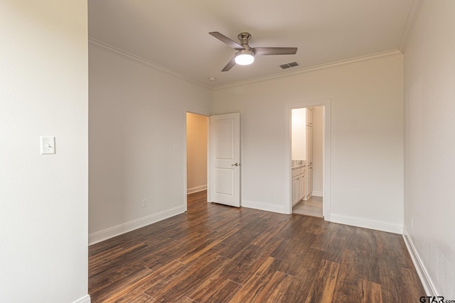 unfurnished bedroom with crown molding, ceiling fan, connected bathroom, and dark hardwood / wood-style flooring