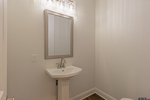 bathroom with hardwood / wood-style flooring