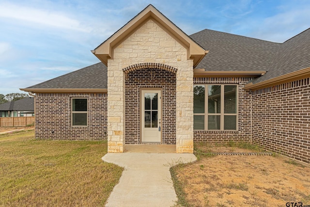 doorway to property with a yard