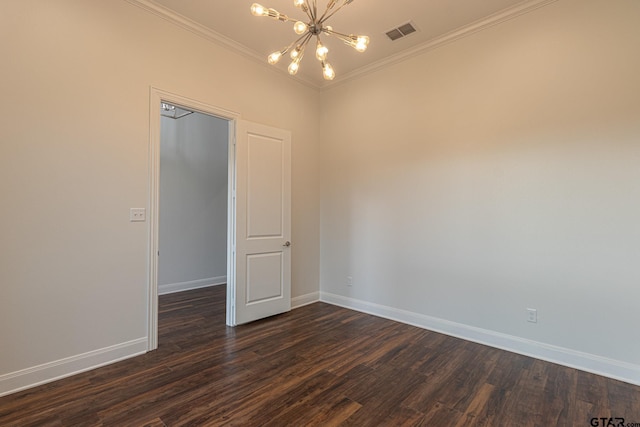 empty room featuring a notable chandelier, crown molding, and dark hardwood / wood-style floors