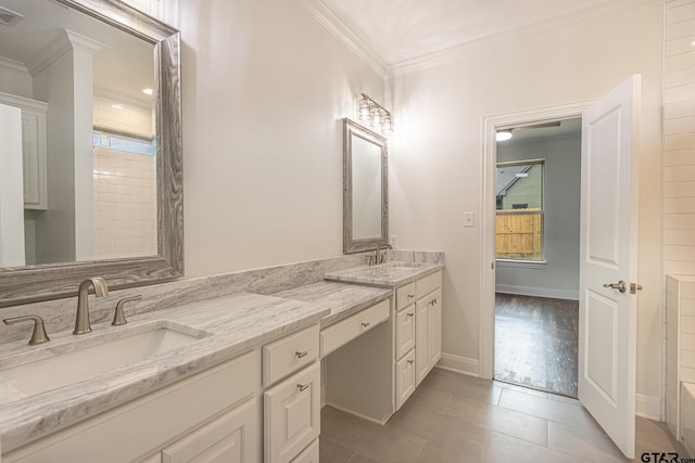 bathroom with vanity, tile patterned floors, ornamental molding, and a healthy amount of sunlight