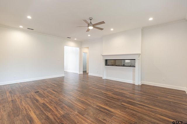 unfurnished living room featuring dark hardwood / wood-style flooring, ornamental molding, and ceiling fan