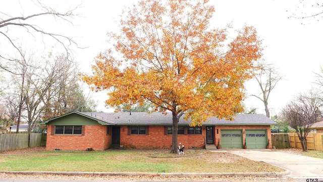 ranch-style home with a front yard and a garage