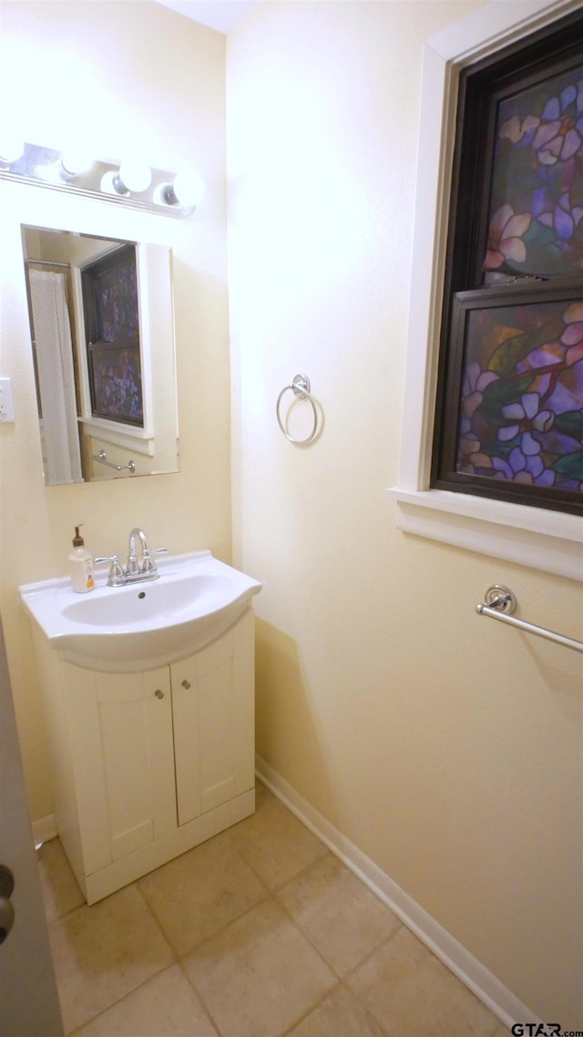 bathroom featuring tile patterned flooring and vanity