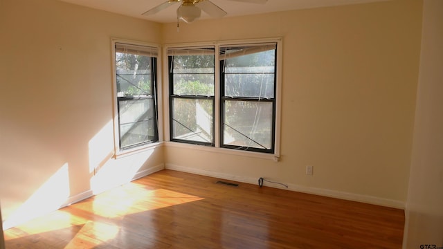 spare room with ceiling fan and light wood-type flooring