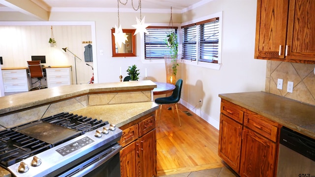 kitchen featuring stainless steel appliances, tasteful backsplash, crown molding, pendant lighting, and light tile patterned floors