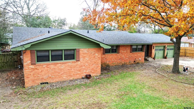 exterior space with a garage and a lawn