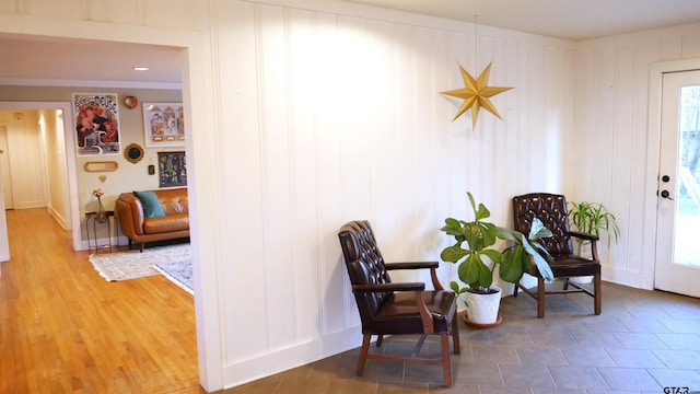 living area with plenty of natural light and crown molding