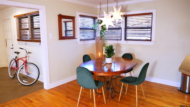 dining space featuring an inviting chandelier and hardwood / wood-style flooring