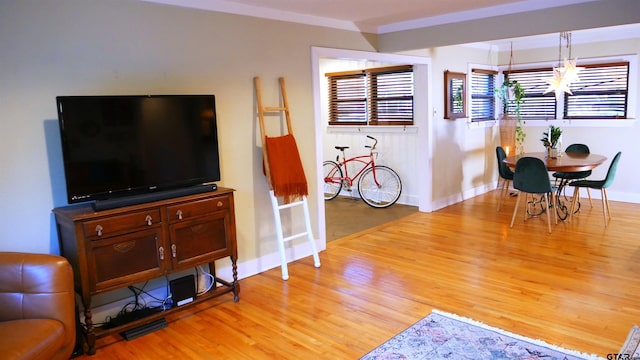 living room featuring light hardwood / wood-style floors and a notable chandelier