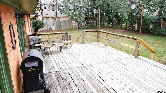 wooden terrace featuring a yard