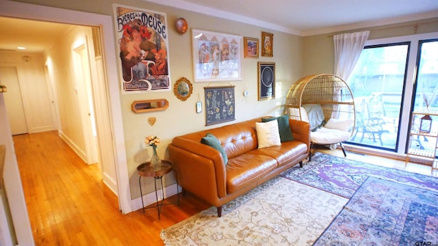 living room featuring crown molding and light wood-type flooring