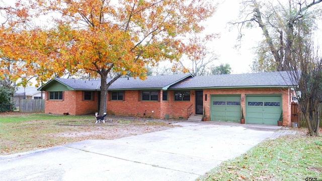 ranch-style house featuring a front yard and a garage