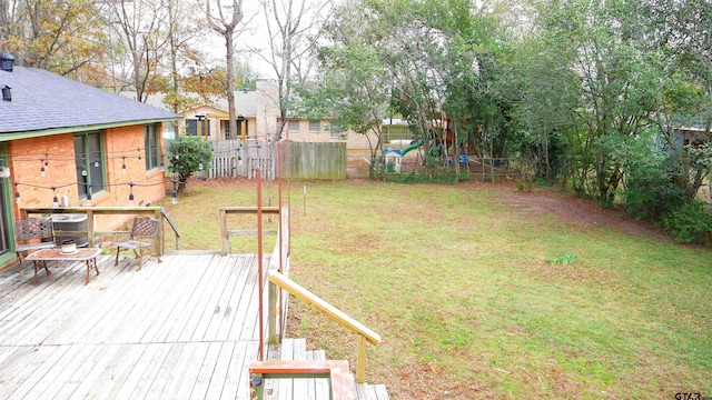 view of yard featuring a wooden deck and central AC unit