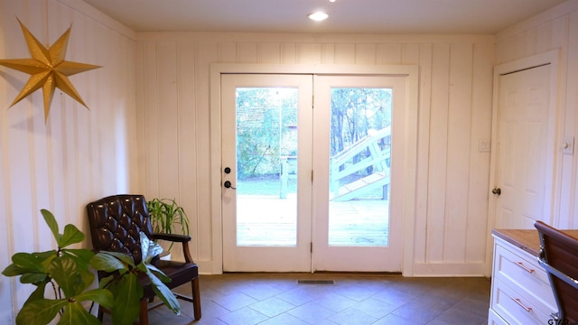 entryway featuring wooden walls