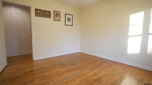 empty room with light hardwood / wood-style floors