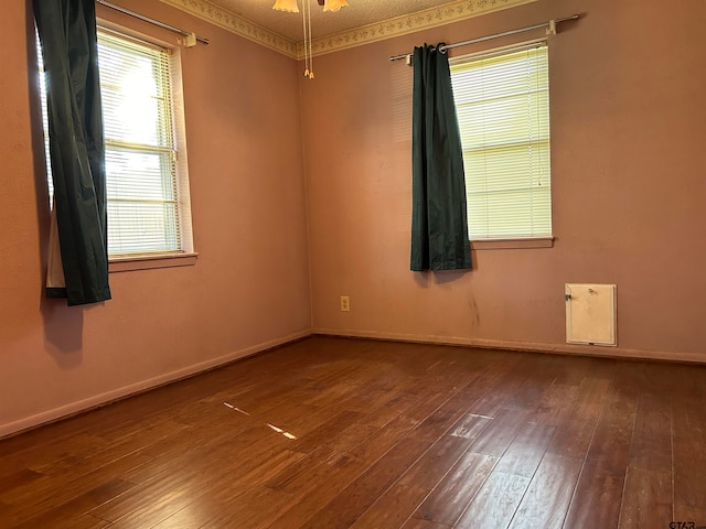 empty room featuring ornamental molding, dark hardwood / wood-style floors, and ceiling fan