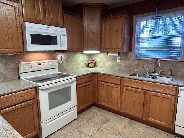 kitchen featuring light tile patterned flooring, backsplash, pendant lighting, sink, and white appliances