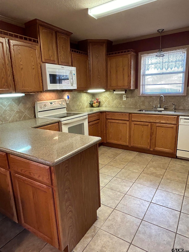 kitchen featuring backsplash, white appliances, sink, and pendant lighting