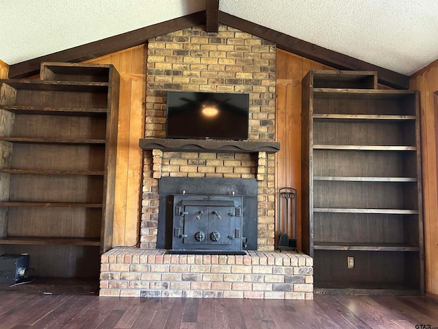 unfurnished living room featuring dark hardwood / wood-style flooring, wooden walls, and vaulted ceiling