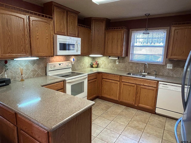 kitchen with sink, light tile patterned floors, hanging light fixtures, white appliances, and crown molding