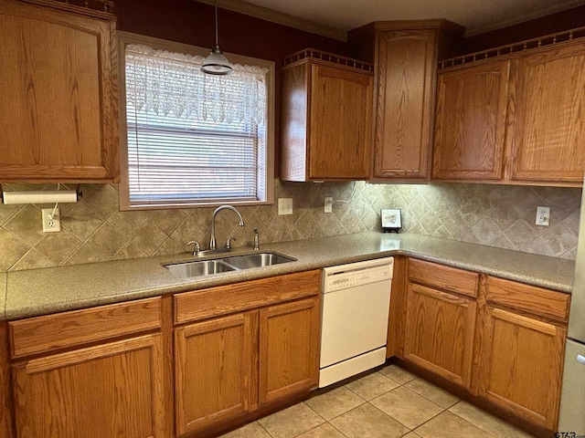 kitchen featuring dishwasher, sink, tasteful backsplash, light tile patterned flooring, and pendant lighting