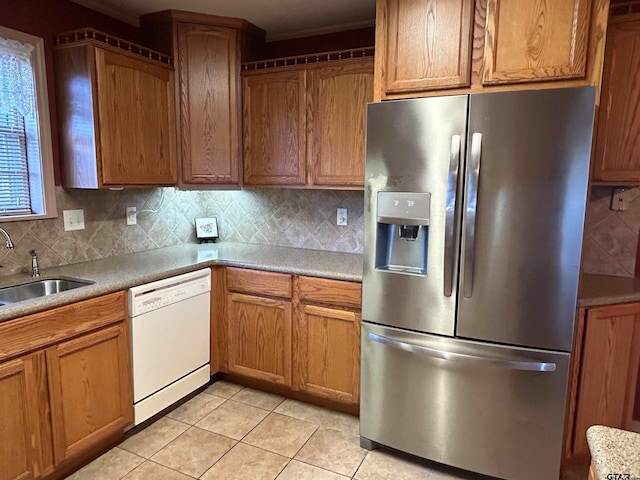 kitchen with light tile patterned flooring, sink, backsplash, stainless steel fridge with ice dispenser, and dishwasher