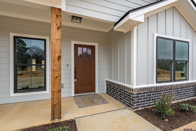 view of exterior entry with covered porch