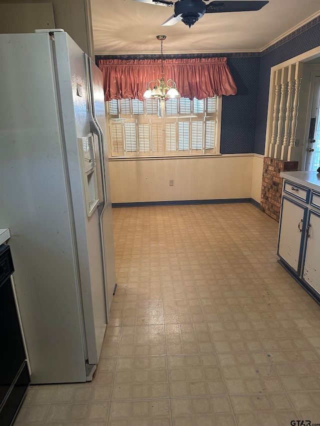 kitchen featuring pendant lighting, white fridge with ice dispenser, and a chandelier