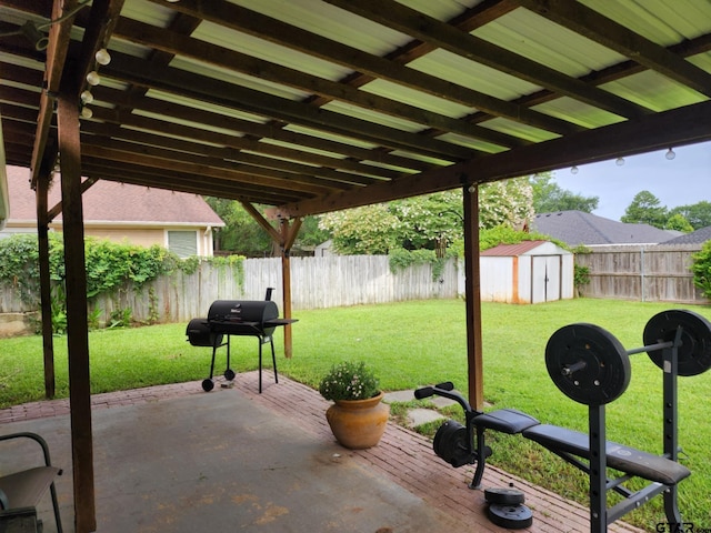 670 Frederick Cir, Flint, TX 75762 - fenced backyard featuring area for grilling, a patio area, and a shed