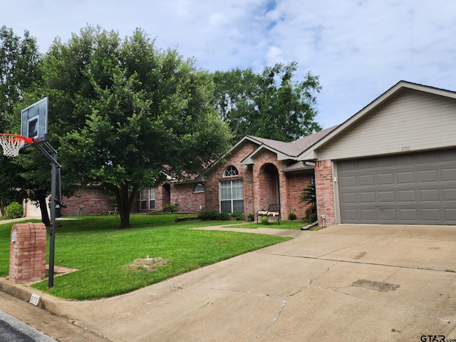 670 Frederick Cir, Flint, TX 75762 - view of front of house with brick siding, a front lawn, driveway, and a garage