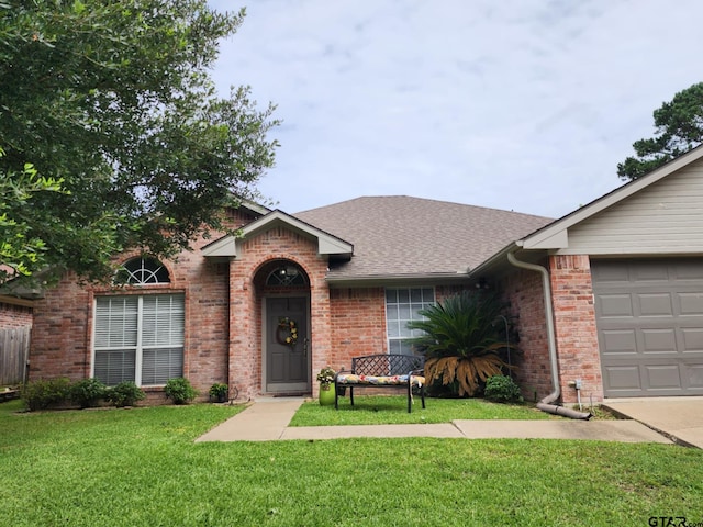 670 Frederick Cir, Flint, TX 75762 - view of front facade featuring brick siding, a front lawn, a shingled roof, and a garage