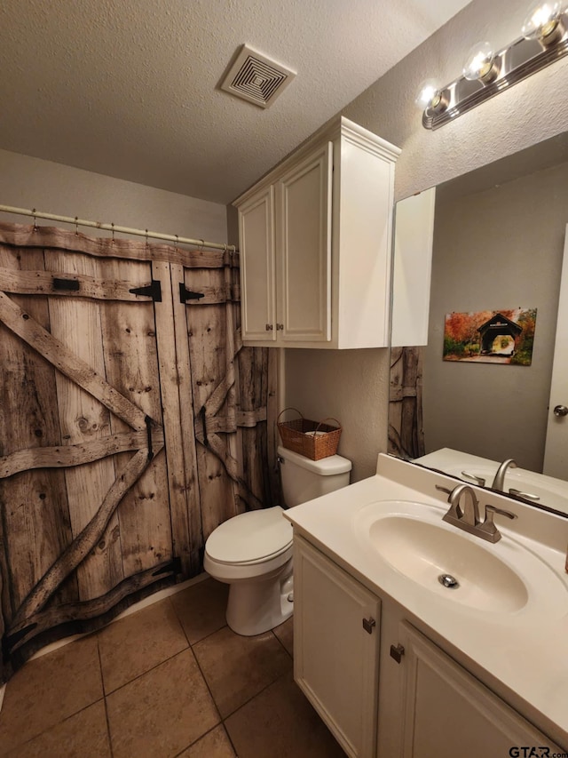 670 Frederick Cir, Flint, TX 75762 - bathroom with vanity, tile patterned floors, a textured ceiling, and a shower with curtain