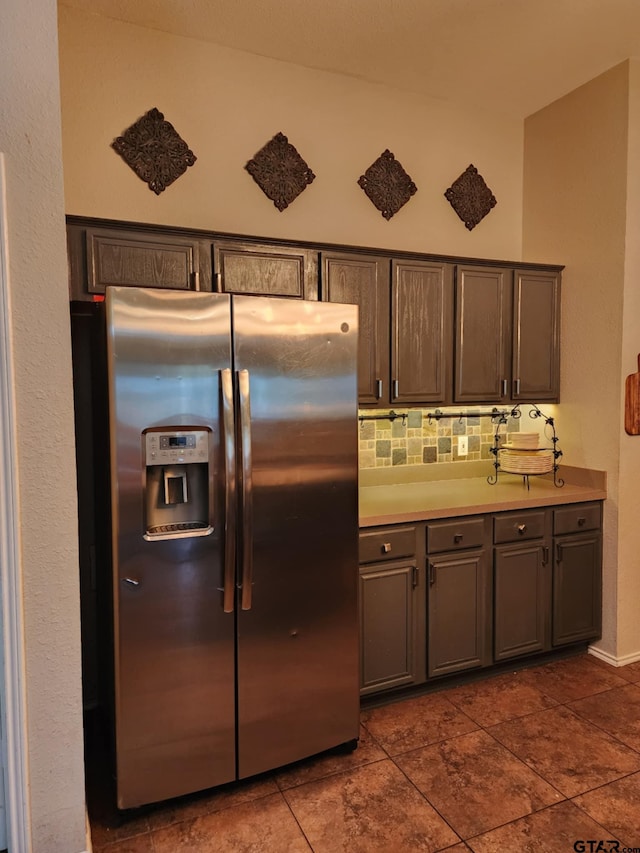 670 Frederick Cir, Flint, TX 75762 - kitchen with stainless steel fridge, tasteful backsplash, light countertops, gray cabinets, and dark tile patterned floors