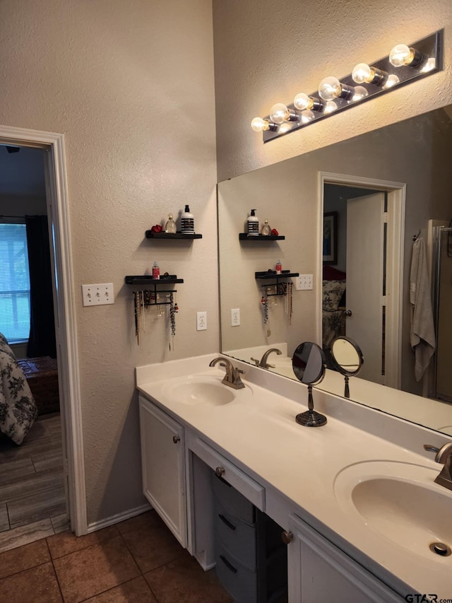 670 Frederick Cir, Flint, TX 75762 - ensuite bathroom with double vanity, tile patterned floors, and a textured wall