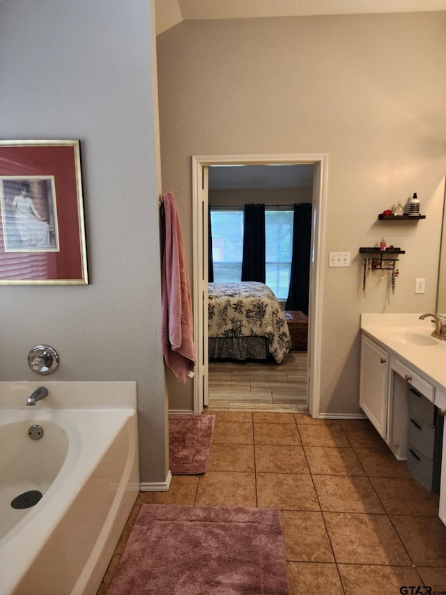 670 Frederick Cir, Flint, TX 75762 - ensuite bathroom with a garden tub, vanity, and tile patterned flooring
