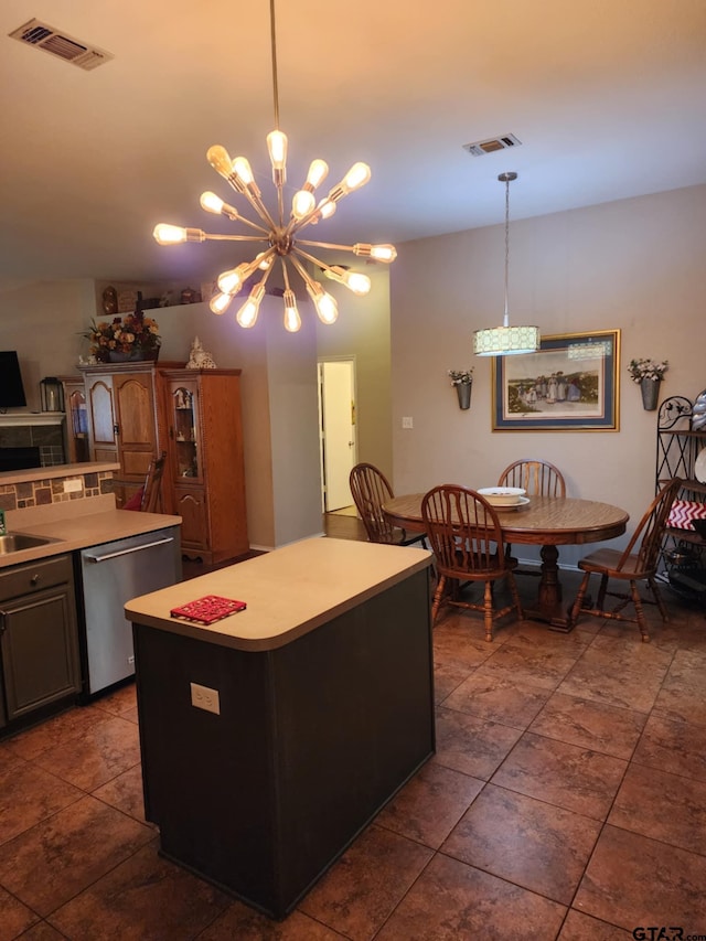 670 Frederick Cir, Flint, TX 75762 - kitchen featuring dishwasher, a center island, a chandelier, hanging light fixtures, and dark tile patterned flooring